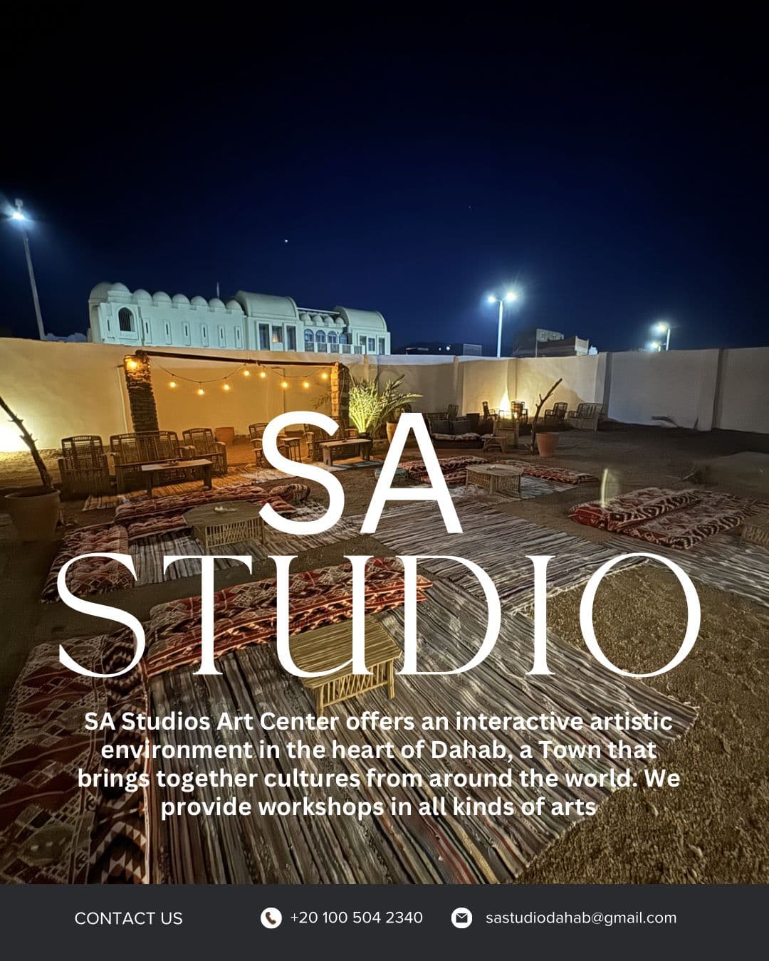 SA Studios Dahab courtyard at night with string lights and floor seating