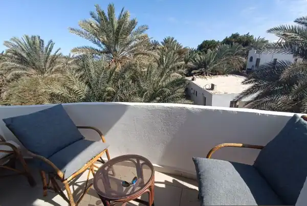 Private balcony with palm views at an SA Studios stay in Dahab